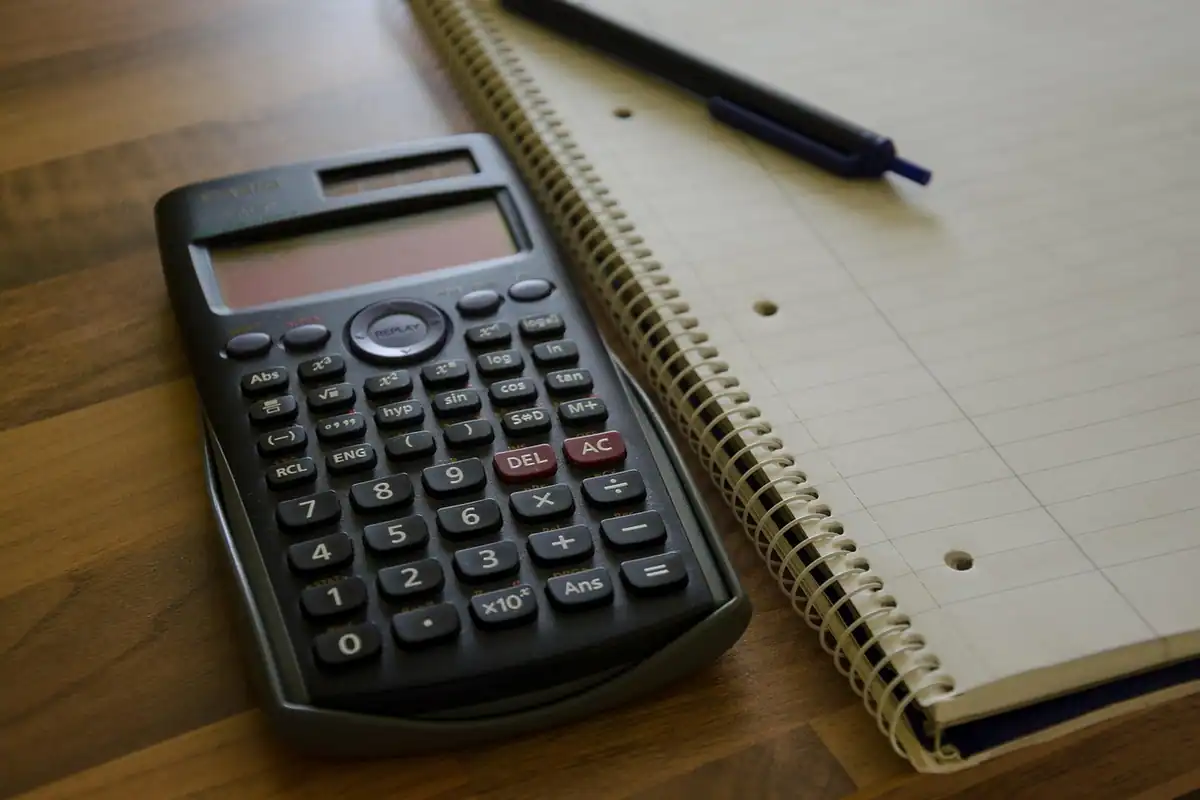 Calculator, caiet și pix pe masă, pentru planificarea bugetului familiei